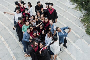 young Latin graduates students group celebrating at University campus in Mexico Latin America,...