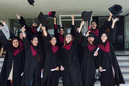 young Latin graduates students group celebrating at University campus in Mexico Latin America, portrait of hispanic people at college 