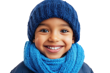 Bright smile of a child dressed in blue clothing during a joyful moment in a cozy indoor setting on a chilly day