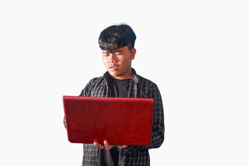 Focused Young Man Working on Red Laptop Computer