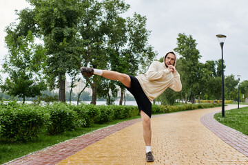 Sporty young man exercises outdoors in a picturesque park setting