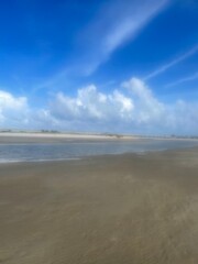 Sunrise at a tropical beach with soft golden tones reflecting on the calm sea. Peaceful and inspiring coastal view.