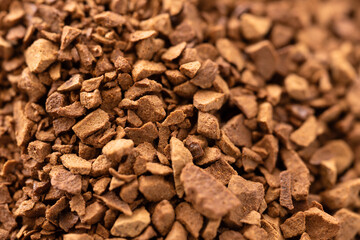 Macro photo of freeze-dried granulated instant coffee. Selective focus