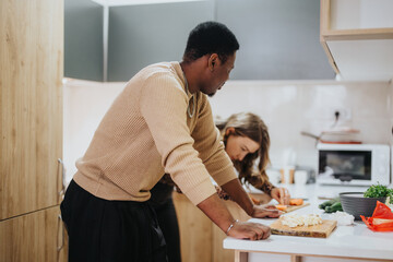 A warm scene of a couple preparing a meal together in a modern kitchen, showcasing the joy of...