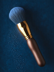 High-quality makeup brush with a luxurious dark brown handle and a light blue synthetic bristle head.