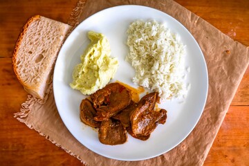 Classic rustic Brazilian food, beef tongue with rice and mashed potatoes. Real food