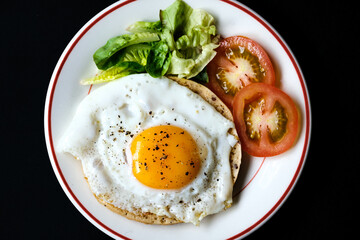 Healthy Fried Egg With Sllced Tomato And Lettuce
