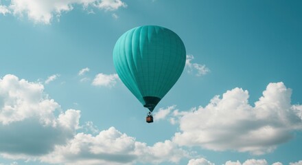 Obraz premium Turquoise hot air balloon floats serenely in a clear blue sky dotted with fluffy white clouds.