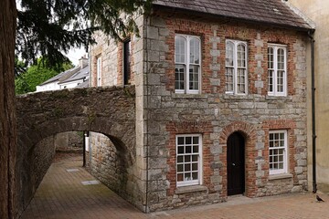 Old stone house with white window in Ireland.