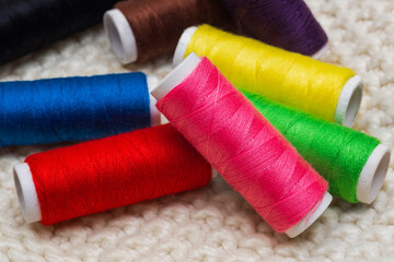 Set of colorful spools of thread close up