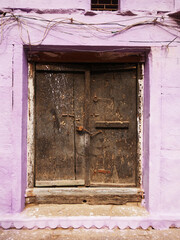 A brown door in a coloured wall in Varanasi, India