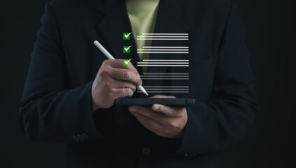 Business professional completing a checklist on a digital tablet using a stylus, representing task completion, organization, productivity, and efficient workflow in modern business operations.