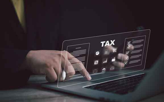 Person using a digital tax application on a holographic interface, symbolizing electronic tax filing, financial data review, compliance checklist, and efficient online tax management system.