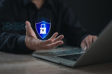 Businessman presenting a digital shield with padlock icon, representing data protection, cyber security, privacy defense, and secure online systems in modern technology environments.