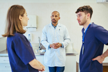 Medical team discussing patient care in hospital room