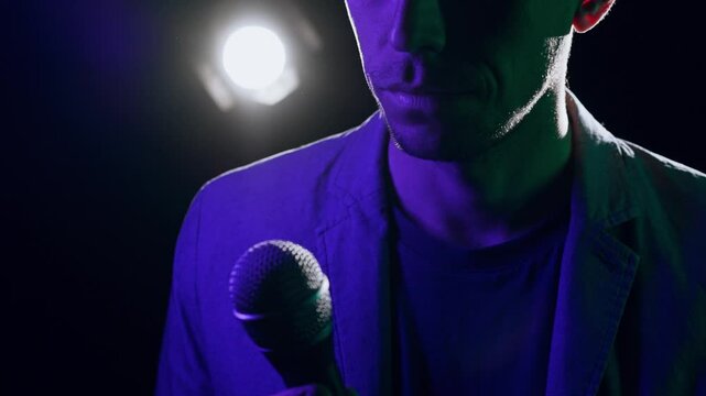 Speaker Making Cross Gesture with Microphone Before Pivotal Lecture