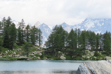 L'incantevole lago di Arpy in Valle d'Aosta, circondato dal verde e dalle montagne.