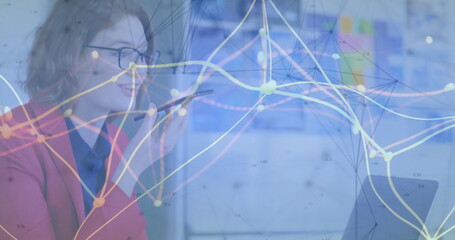 Talking red blazer manager holding smartphone glancing laptop in office with data, copy space