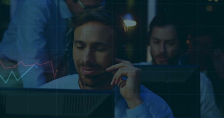 Analyzing trader in blue shirt tracking market data in trading office with headset monitors, charts