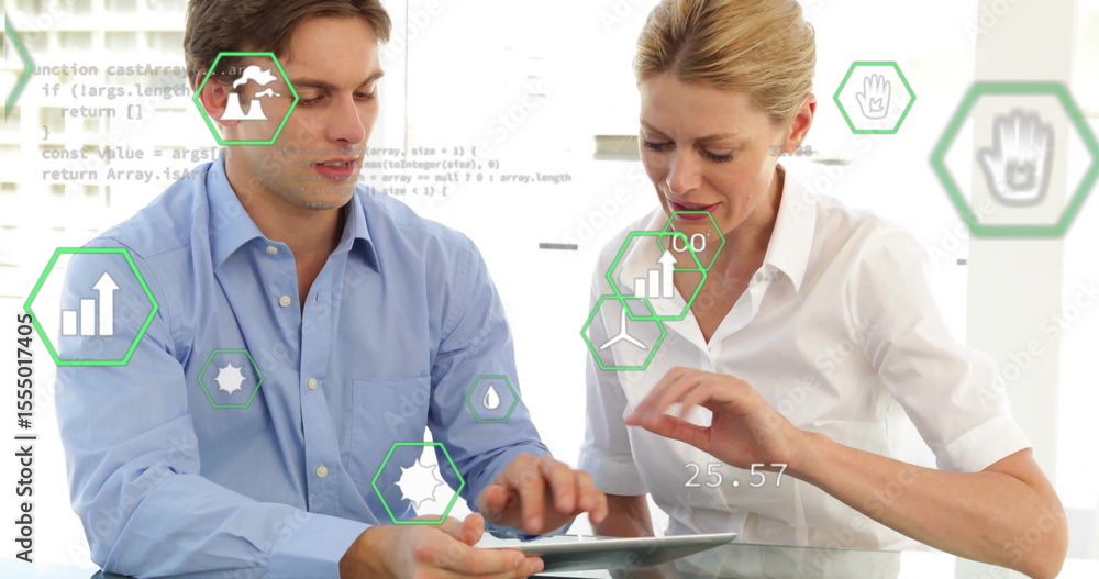 Poster collaborating colleagues in button-down shirts analyzing data on tablet at office with data icons