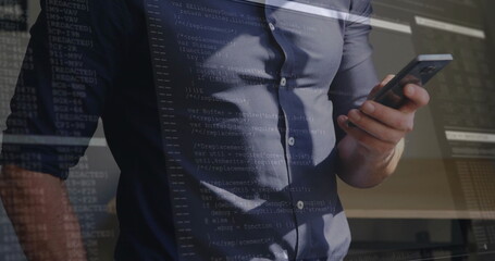 Holding smartphone developer in button-down shirt reviewing code at office, with code overlay