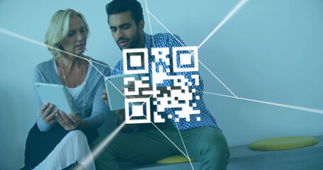 Holding tablets coworkers scanning floating QR code on corporate lounge bench, with yellow cushions