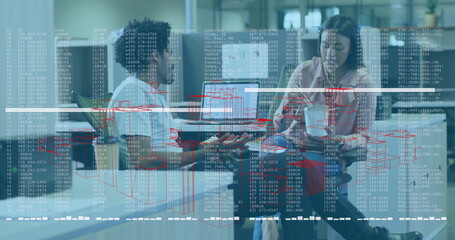 Two colleagues in business attire studying holographic data display in modern office room, with pen