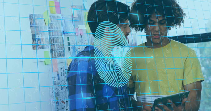Two colleagues in blue and yellow shirts examining tablet with fingerprint grid overlay in office
