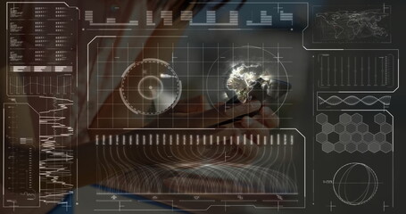 Adult hands in business shirt holding smartphone displaying 3D globe with HUD charts at office desk