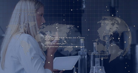 Analyzing data on tablet, woman viewing image with digital world map overlay