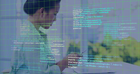 Programming code overlaying scene, business professional using smartphone in office