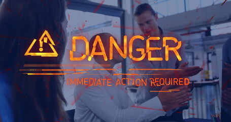 Danger warning text image over people discussing in modern office setting
