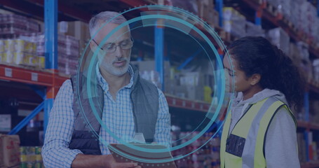 In warehouse, workers discussing logistics with digital data protection overlay image