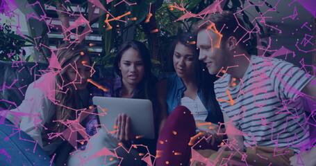 Young adults gathered around tablet with digital network image overlay © vectorfusionart