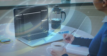 Person working on laptop with data processing image over coffee and notepad
