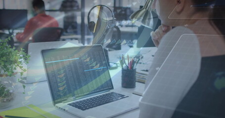 Analyzing financial data with image, businesswoman using laptop in office