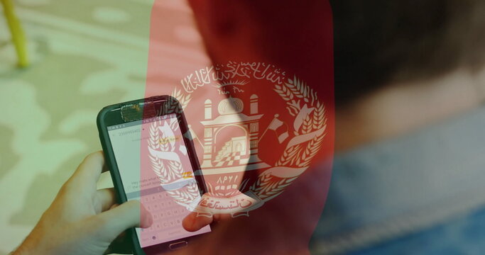 Using smartphone, person viewing image of Afghanistan flag in school setting - Powered by Adobe