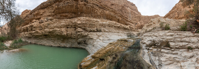 Shallow  narrow mountain stream and small lake in Arugot Stream Nature Reserve near Dead Sea in the southern Israel