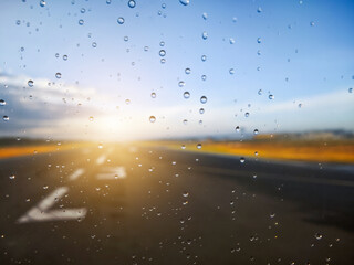 A road with cars on it and raindrops on the windshield
