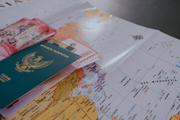Passports and wallet with rupiahs, indonesian and credit card on a map background. Travel concept.