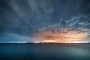 Beautiful night landscape, long exposure clouds over the lake. Starry night. 