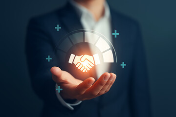 Businessman holding digital handshake hologram, partnership and collaboration technology concept
