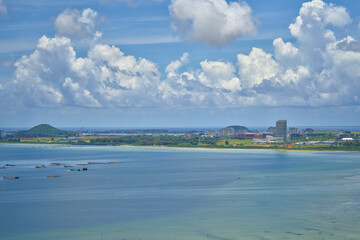 A vast body of water is surrounded by lush trees and mountains
