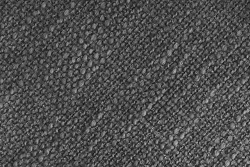 Close up, macro of black woven fabric with detailed texture and diagonal pattern. Textile, cloth, material, fashion, upholstery, or abstract design background.