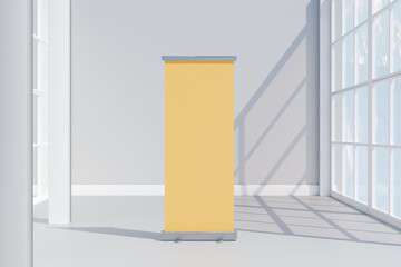 Blank yellow rollup banner in a bright modern room by large windows. 3d rendering