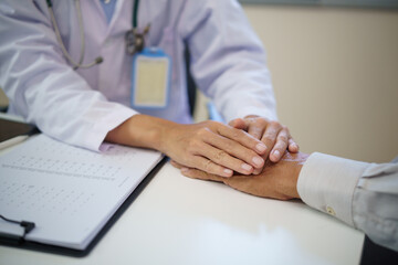 Female doctor showing care and compassion during consultation with an elderly patient.