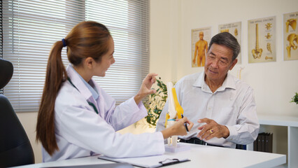 Elderly man consulting with a physician about joint pain and mobility issues in a clinical.