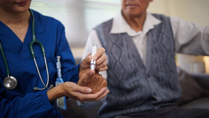 Close up of elderly man receiving glucose monitoring from healthcare worker. Health care concept.