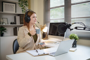 Podcast creator in headphones recording content with a professional microphone setup.