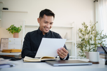 Confident businessman analyzing business report in a contemporary home office.
